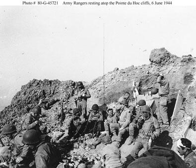 U.S. Army Rangers rest atop the cliffs at Pointe du Hoc, June 6, 1944. Official U.S. Navy photograph, collection in the National Archives. U.S. Army Rangers