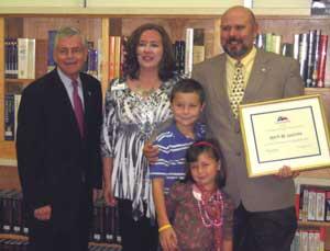 Mark LaCroix (right) with family (center) and State Rep. Tom Craddick (left).