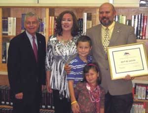 Mark LaCroix (right) with family (center) and State Rep. Tom Craddick (left).