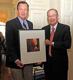 Joe Krier and Julius Glickman. Glickman is presenting Krier with a Bill Wright photograph to thank him for his service to the board. 
