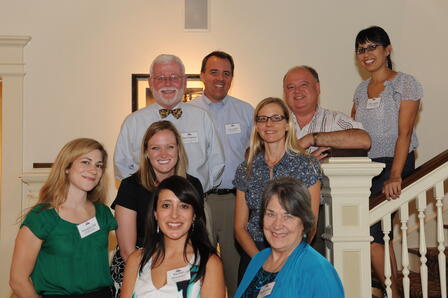 Humanities Texas staff and education constituents. Clockwise, from top of stairs: Julia Aguilar, HTX senior program officer; Joe Ramirez, social studies curriculum supervisor for Austin Independent School District; Erica M. Bsumek, associate professor of history at The University of Texas at Austin; Rachel Hernandez, social studies education specialist for the Education Service Center Region XIII; Susanna R. Hill, HTX development officer; Liz James, HTX coordinator of educational programs; Jim Furgeson, a history teacher at Stephen F. Austin High School who is a past OTA winner; and Eric Lupfer, HTX director of grants and education. Education staff and constituents