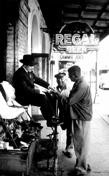 Griffin collects his fee from a dapper patron at Sterling Williams's shoeshine stand in the French Quarter of New Orleans. Griffin worked with Williams off and on for a week in mid-November 1961. Photo by Don Rutledge, reprinted with the permission of Wings Press. Griffin working at a shoeshine stand